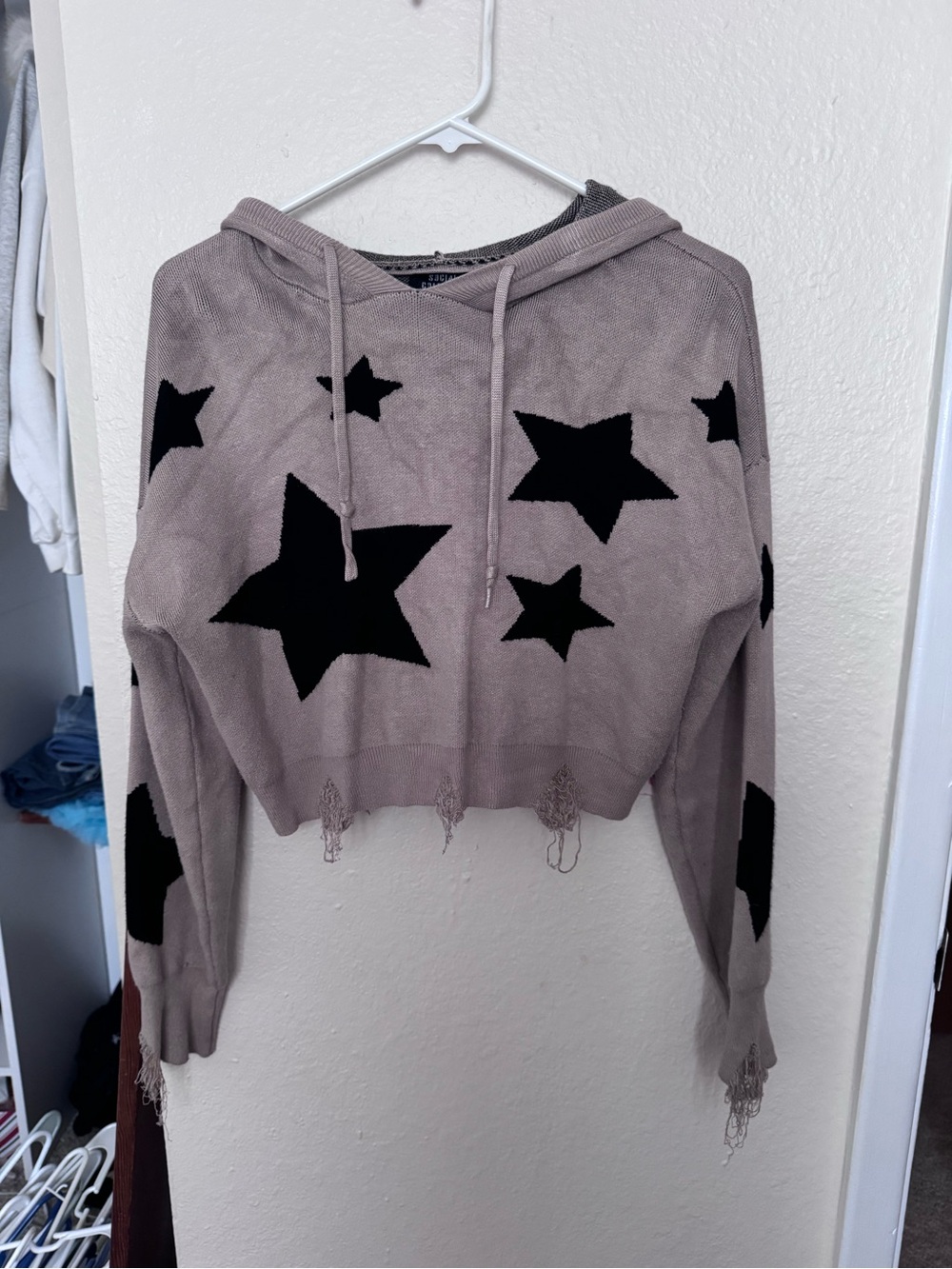 Light taupe color with black stars distressed cropped hoodie